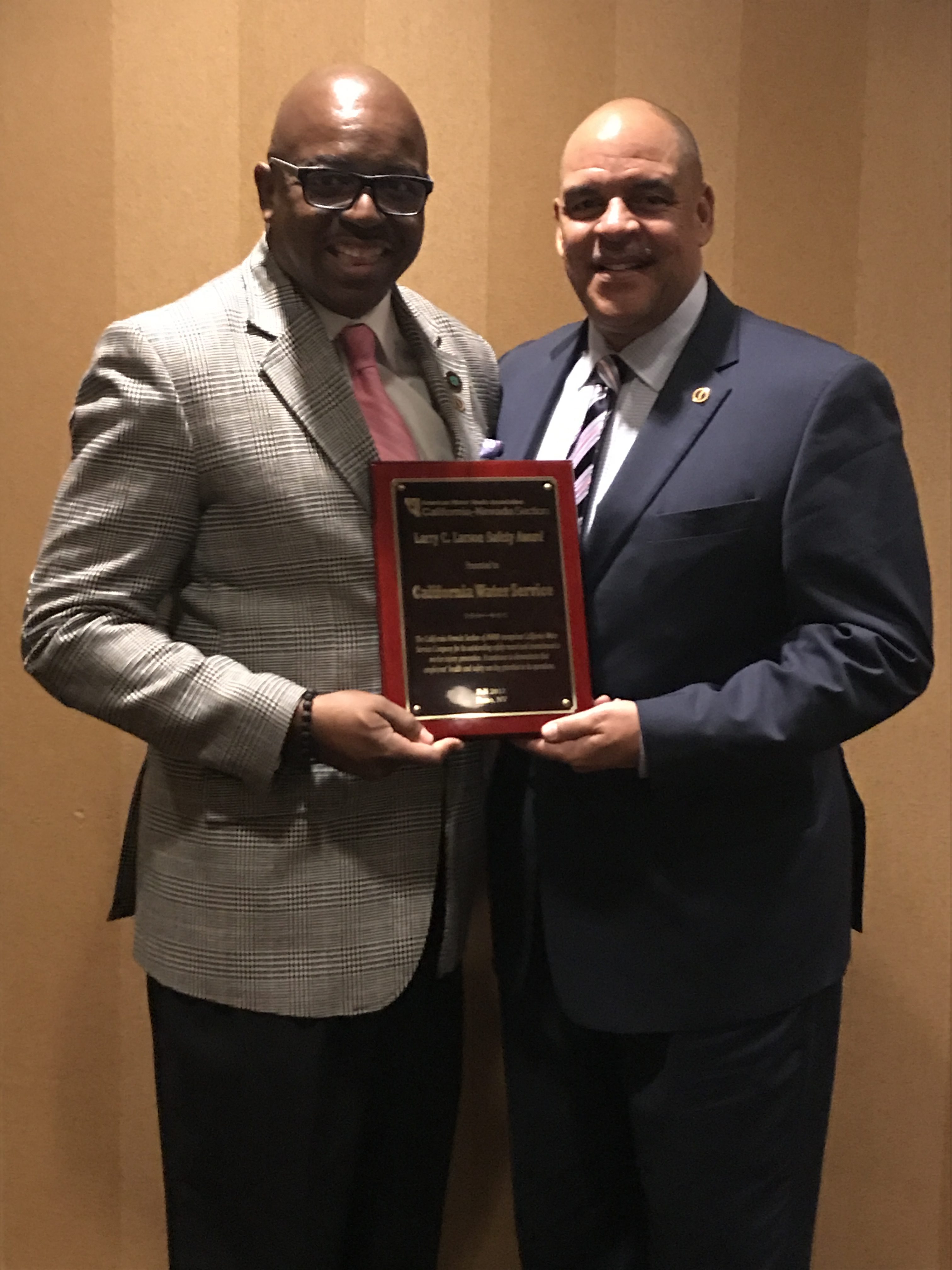 Chief Safety Officer Gerald Simon and Safety Program Manager Alex Williams accept the AWWA Safety Award.