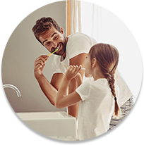 Parent and child brushing teeth