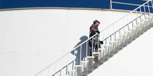 Employee walking up stairs on water tank
