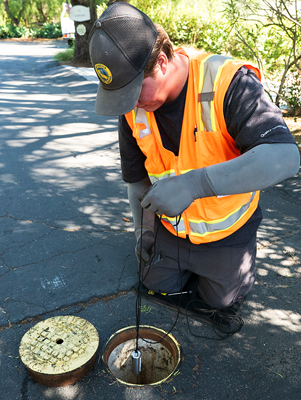 Crew member installing a pressure monitor