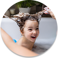 Un niño se lava el pelo en la bañera